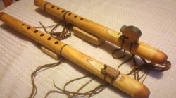 Two early flutes in New Zealand Macracarpa, with Rimu blocks. To the rear, the block depicts our iconic NZ native bird, the Kiwi. The nests were created from model aircraft birch plywood. Leather tied with wood beads.